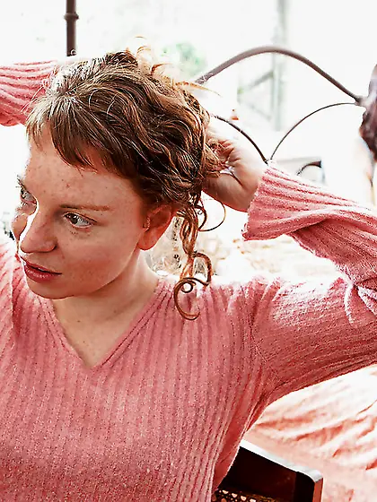 Redheaded girl arching her back during a hot lesbian sex sesh