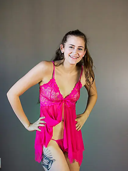 Innocent-looking gal takes off pink lingerie and poses with her
