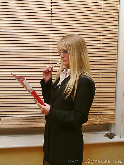 Fair haired secretary Sharon with shy eyes displays her nice bla