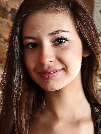 Hot brunette teen Irina J sexily smiles into the cam when showin