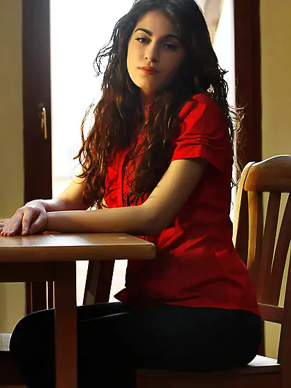 Long-haired solo brunette in jeans takes bra off to reveal her b