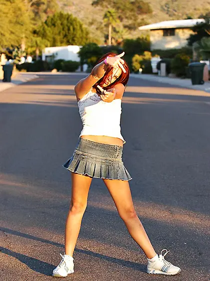 Cute redhead babe,  Dani Woodward gets off her shirt and shows he