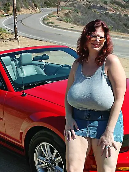 Hot Toni KatVixen posing by a red car