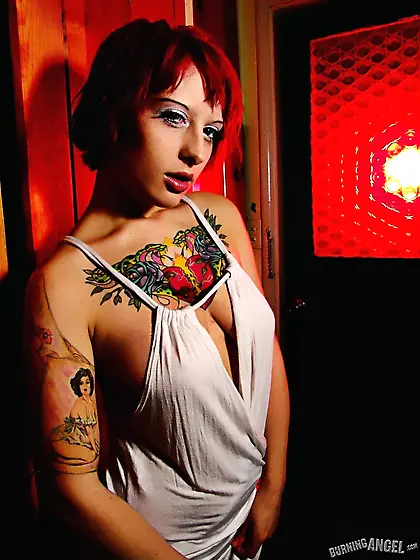 Teen alt girl with playful eyes is too thoughtful to stay dresse