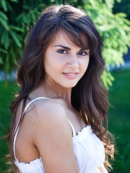 Slim brunette shows her body while making splashes and playing w