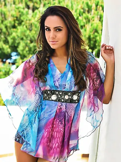 Bewitching porn model hikes up her dress to show tits and thong