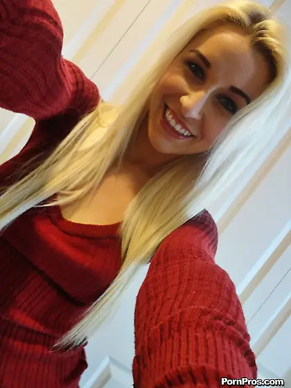 Blonde female with tattooed hands takes boobs to light in front