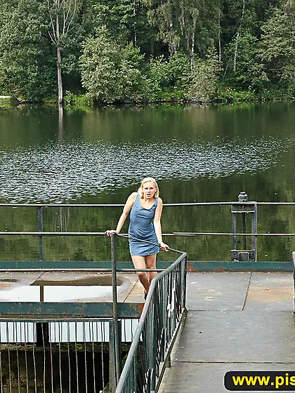 Outdoor pissing on a village embankment