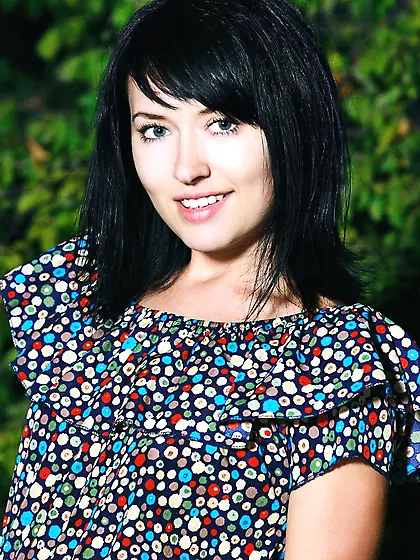 Smiling brunette girl Ramina Femjoy is stripping and showing tan