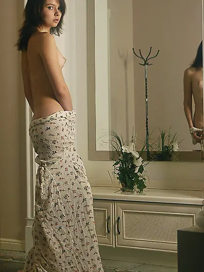 Mysteriously appealing brunette teen displaying her attractive b