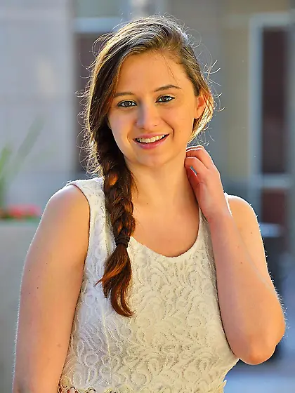 Teen chick Elektra Rose is sitting on escalator with pulled up s