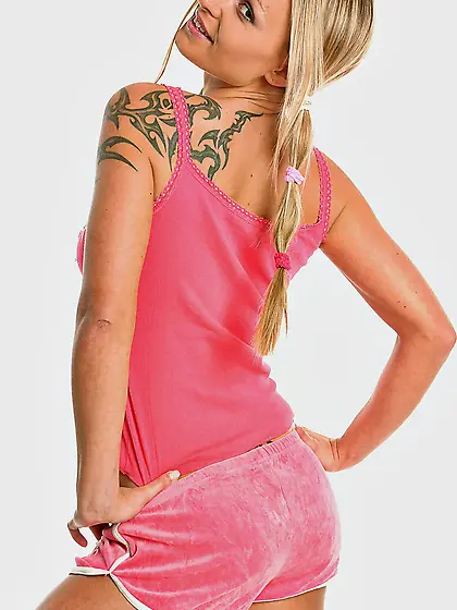 Slender baby doll Liliane Tiger shows her tattoos and pierced cl