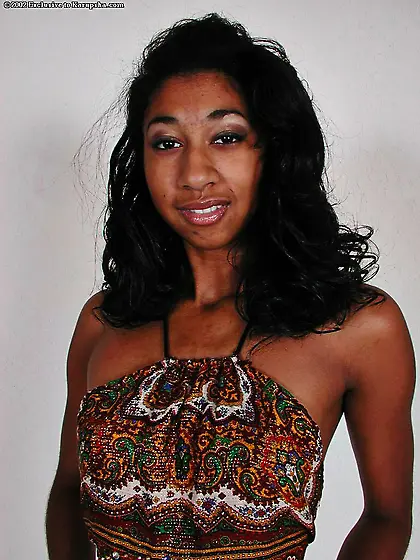 Slender chocolate skinned babe Penelope Lila gets naked and spre