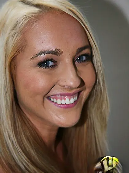 Blond hussy Ashley Stone handles two black cocks in a gloryhole