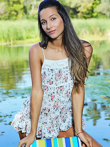 Slender chick doesn't hesitate to pose nude in fresh air near ri