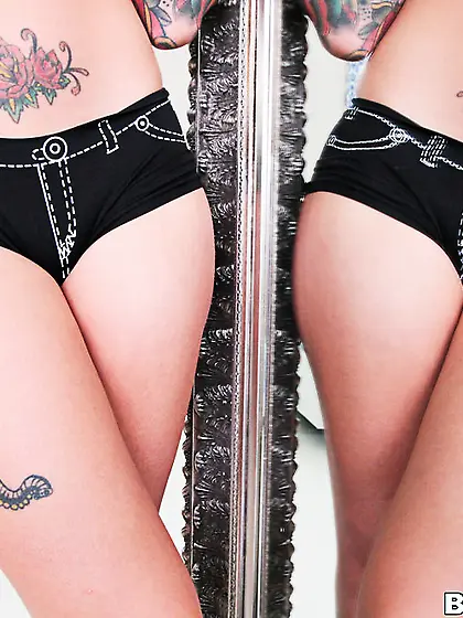 A flamboyant,  gorgeous eyed,  tattooed babe with great tits sucks