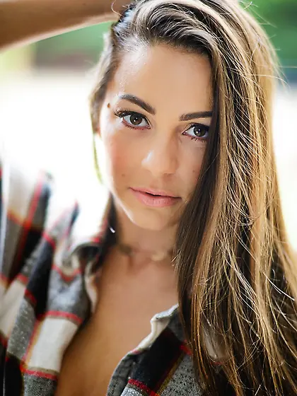 There is a tree and busty girl with beautiful face likes to pose