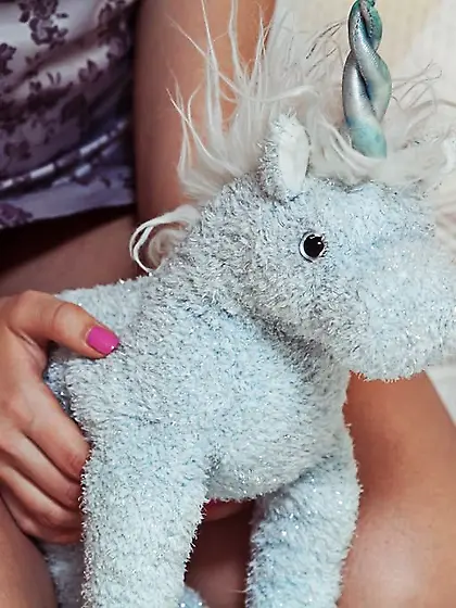 Unicorn-loving teenage beauty spreads her legs to show off pussy