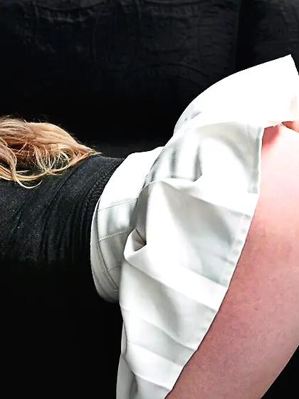 Classy dame in a white skirt strokes dick