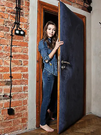 Beauty in denim suit performs passionate striptease against leat