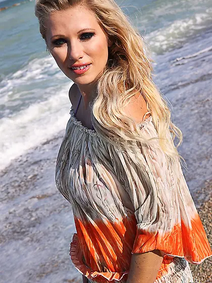 Beautiful blonde model Nikita Valentin strips on the beach and s