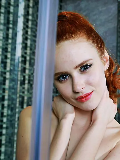 Redheaded Russian girl showing her flawless wet body in the show