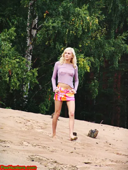 Beautiful teen peeing in the beach
