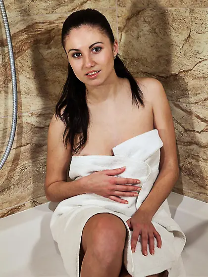 Handsome brunette Azzura is gently washing her slender shaped bo