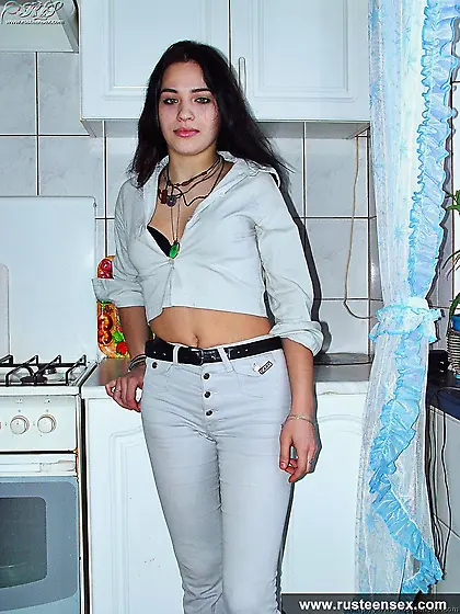 Russian teen brunette undressing in the kitchen