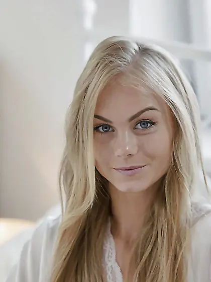 Long-haired Euro blonde wakes up and seductively poses naked on