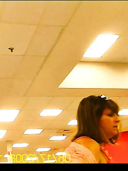 Latino putting on sweater over sundress