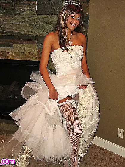 Melissa Midwest dressed in wedding dress shows and fingers her s