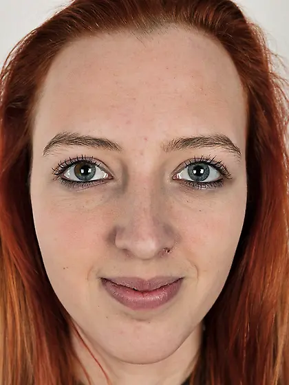 Pale chick with red hair unveils small breasts but doesn't take