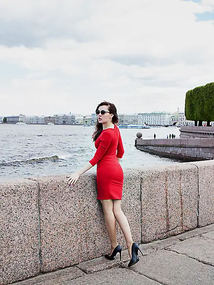 Red dress wavy-haired brunette revealing her hairy slit on a cha