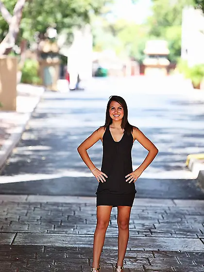 Dazzling girl with sexy smile hides in side street to show her p