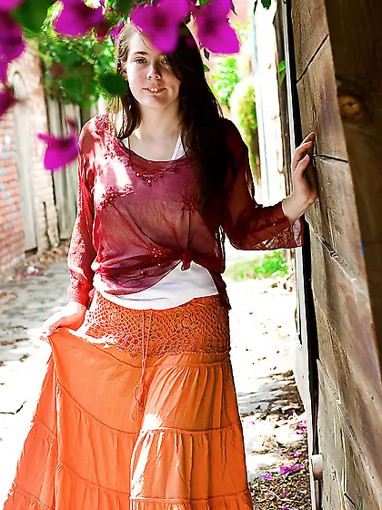 Young woman with playful smile flashes her tits and hairy vagina