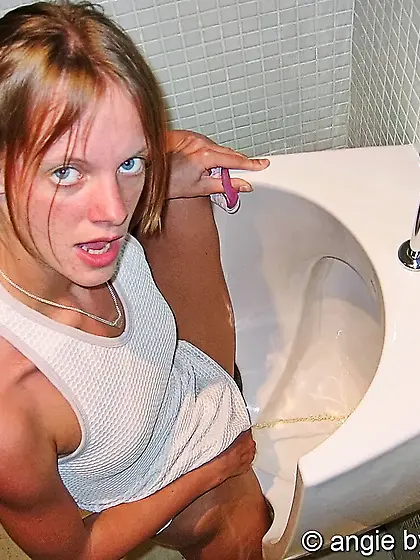 Amateur Petty pees on the men's toilet