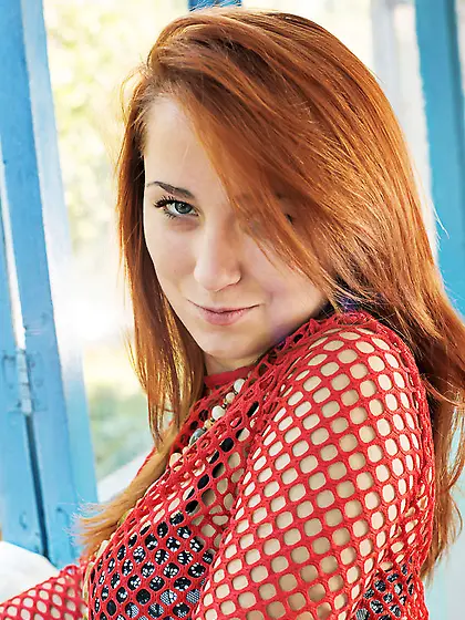 Fiery young redhead exposes her big natural tits and smooth cunt