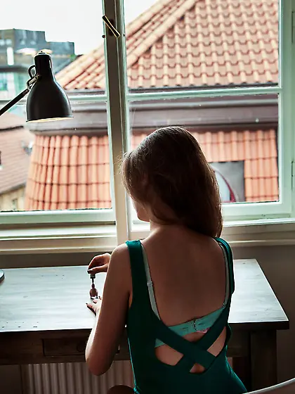 Brown-haired teen with cute bed hair slowly but surely undressin