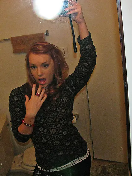 Playful ginger cutie plays with her own hot body and with a long