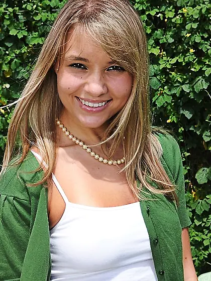 Cheerful blond-haired teen in polka dots panties shows her breas