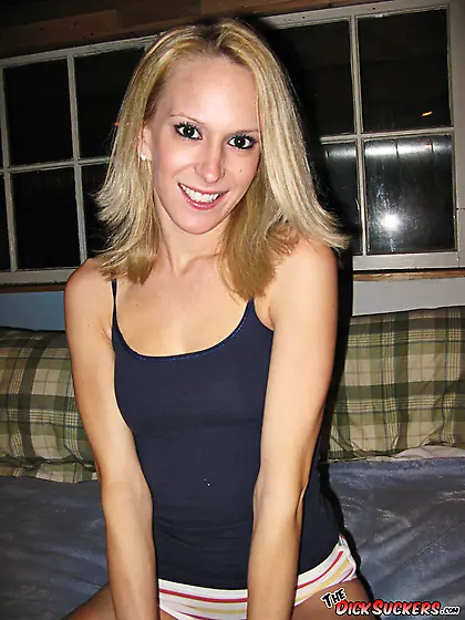 Blonde teases her perky chest in bed.