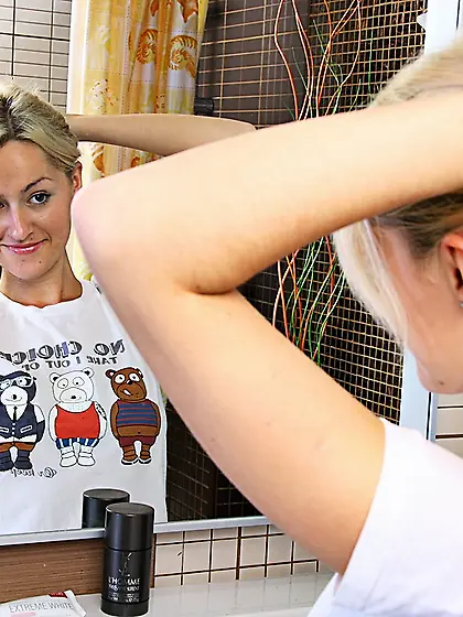 Joan Miller gets naked and the showers her smooth pussy in the b