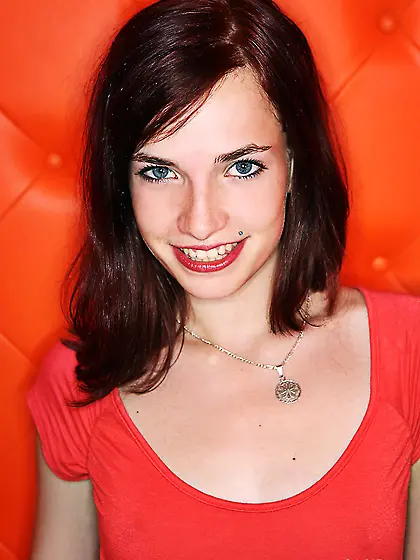 Smiling brunette takes skirt