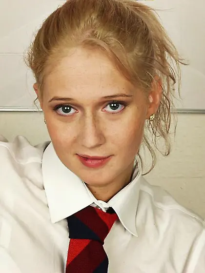 Schoolgirl removes her outfit and plays with a large carrot