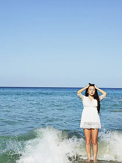 Dark-haired wavy-haired beauty masturbating while eating the des