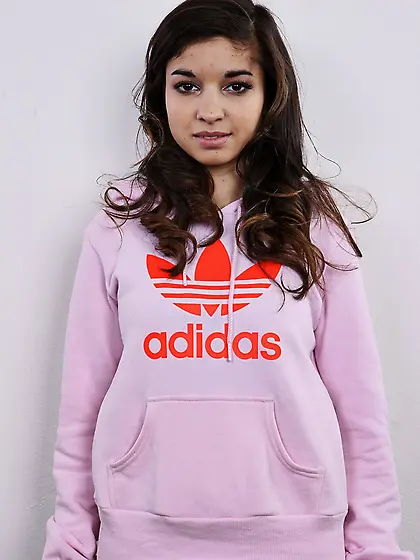 Model takes sweatshirt and striped tunic off continuing with bra