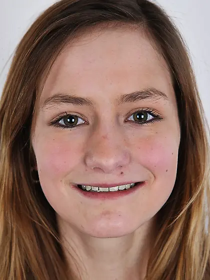 Young woman with different smile deletes sweater and jeans to st