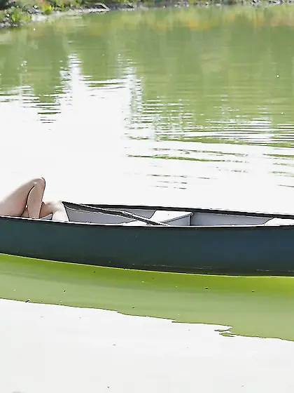 Slutty blonde girl in a birthday suit rests by a lake and mastur