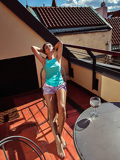 Ponytailed brunette sunbathing and listening to some fine music